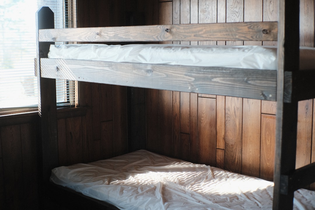 a-bunk-bed-in-a-room-with-wooden-walls-oaa1ydsvsns