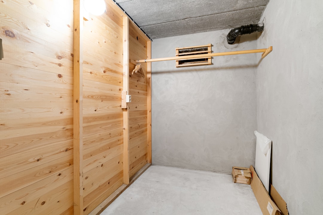 a-room-with-a-wooden-wall-and-a-white-bed-0ttalp7tvtw